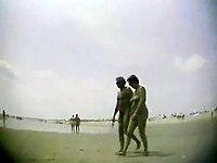 A couple of absolutely naked lovers are enjoying the nature on the nudism beach!