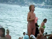 The naked babe is proudly walking along the nudist beach demonstrating the perfectly shaped and very hot body!
